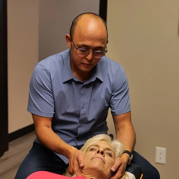Dr. William Hong treating neck pain of patient