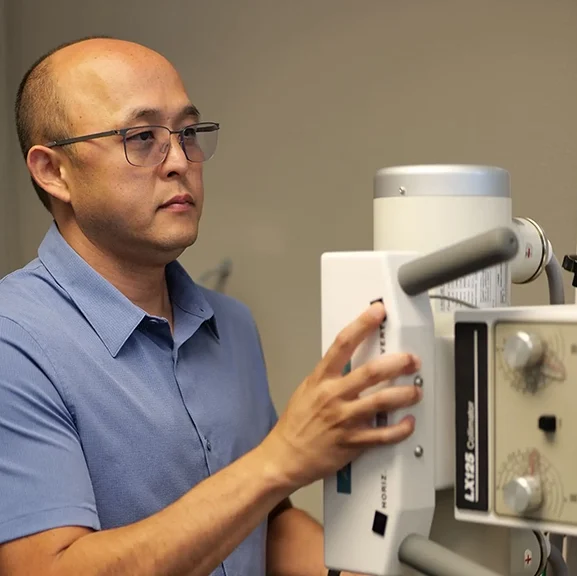 Dr. William Hong with chiropractic machine