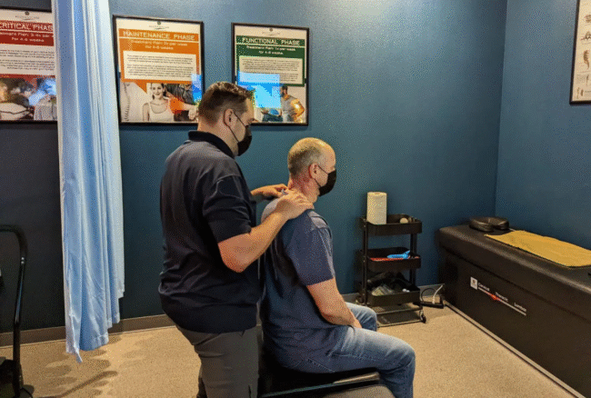 Therapist performing chiropractic neck adjustment