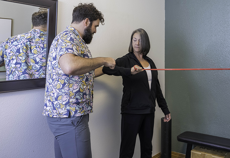 person working with chiropractor for work injury treatment